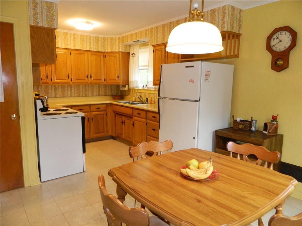 82 Elm Road Hickory, PA 15340 - Photo 9 of 25 The eat in kitchen is cheerful yellow with quality oak cabinetry. Electric stove and refrigerator are included in the sale.