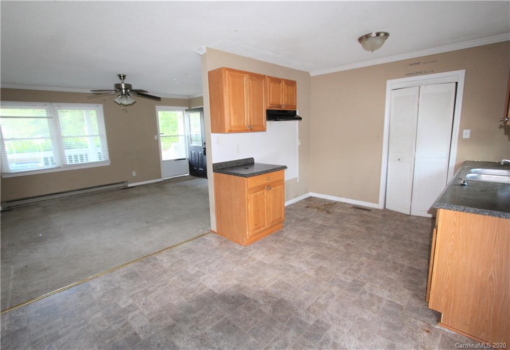 308 Sandy Ridge Church Road Morven, NC 28119 - Photo 4 of 10 an empty room with windows and cabinet