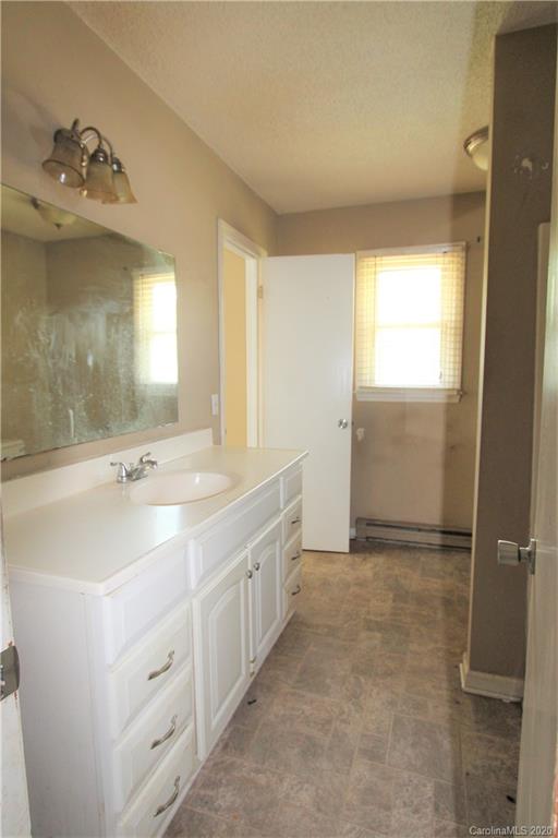308 Sandy Ridge Church Road Morven, NC 28119 - Photo 9 of 10 a bathroom with a double vanity sink a mirror and a shower