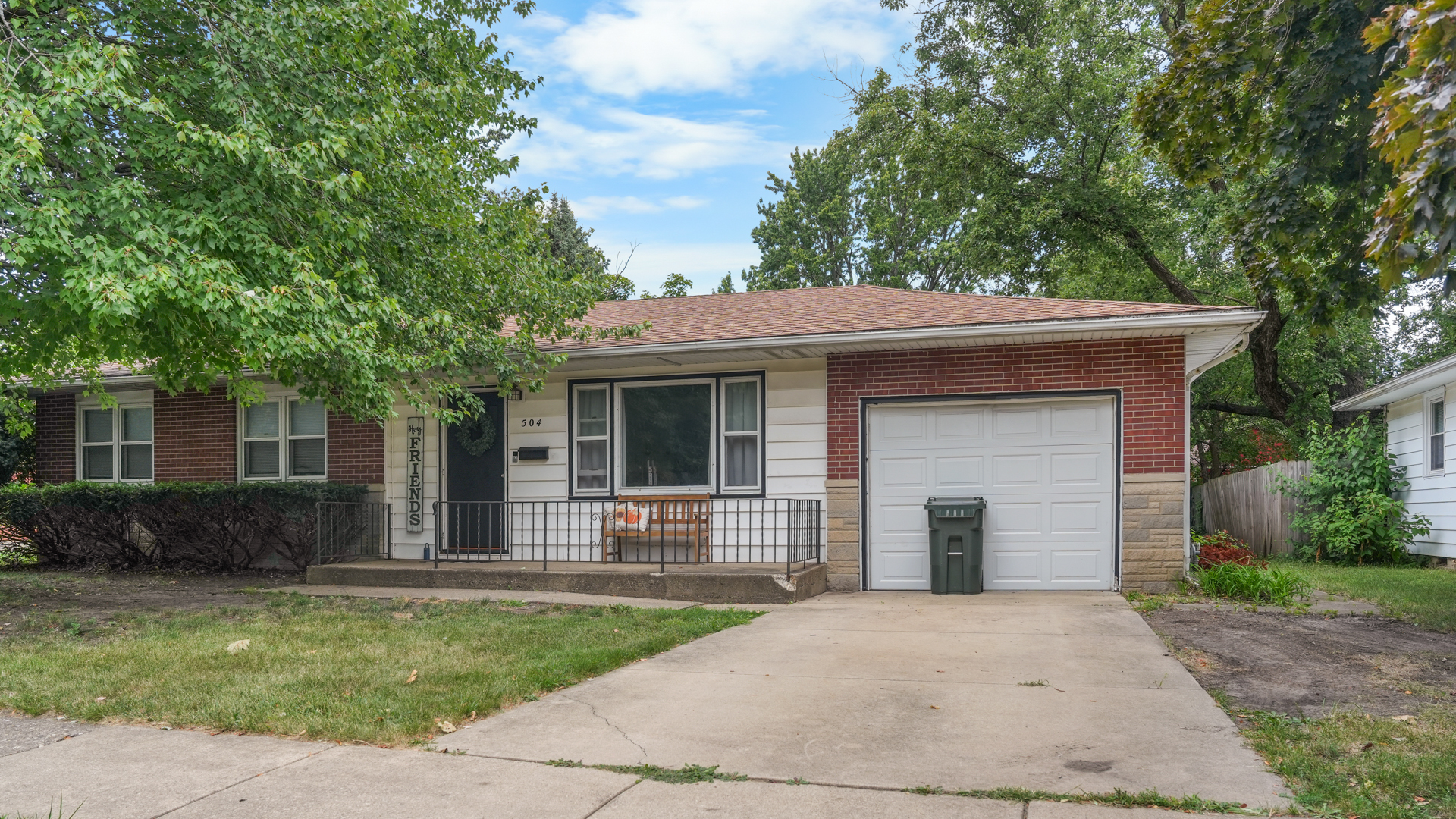 504 East Florida Avenue Urbana, IL 61801 - Photo 2 of 19 a front view of a house with a garden and trees