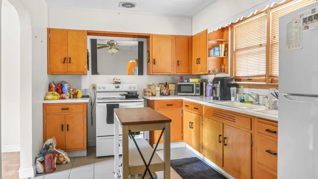 a kitchen with stainless steel appliances sink cabinets and window