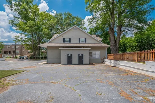 a big house with trees in the background