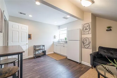 a kitchen with a refrigerator and a stove top oven