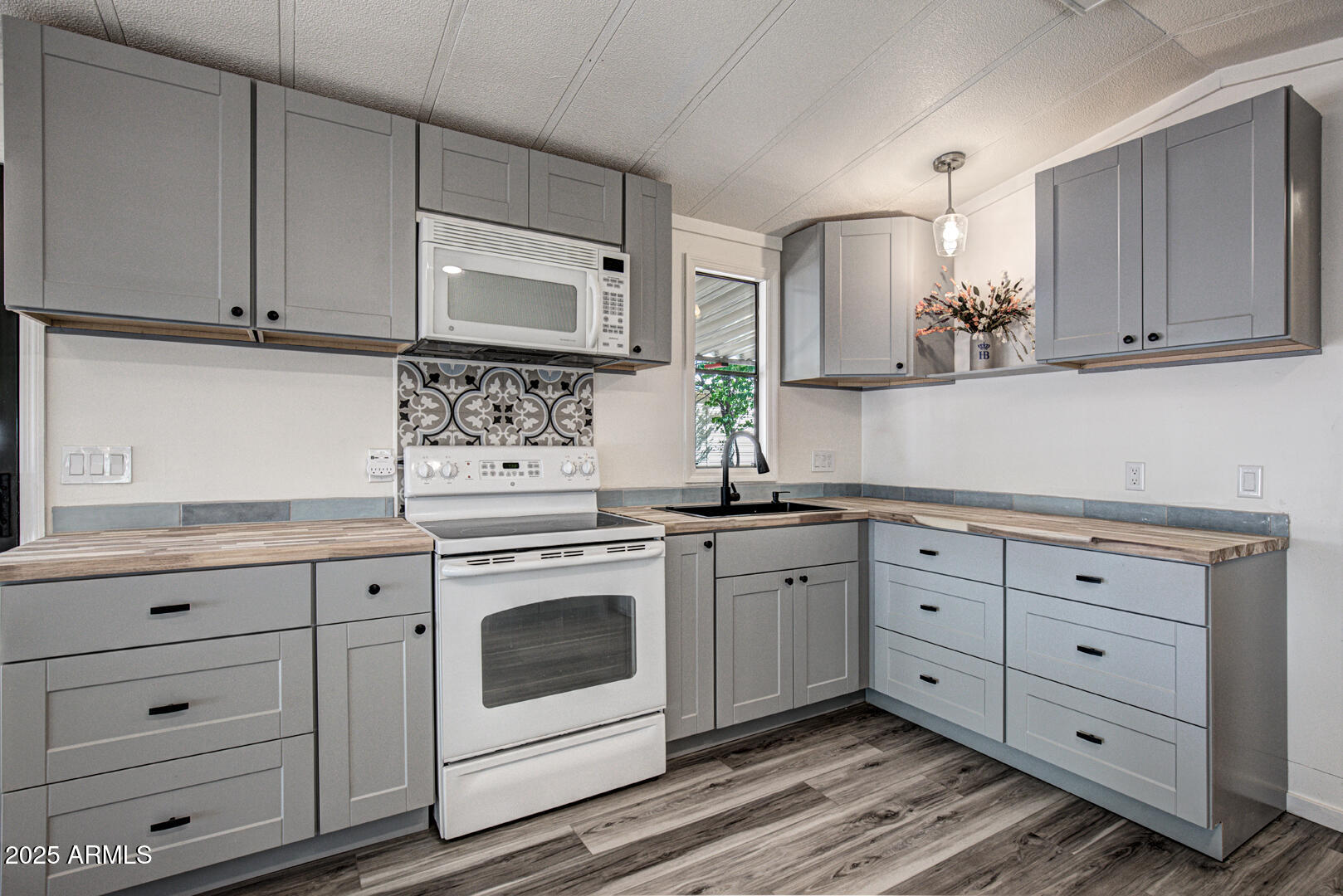 16 North Star Vale Road, Unit 11 Star Valley, AZ 85541 - Photo 11 of 24 a kitchen with granite countertop white cabinets stainless steel appliances and a sink