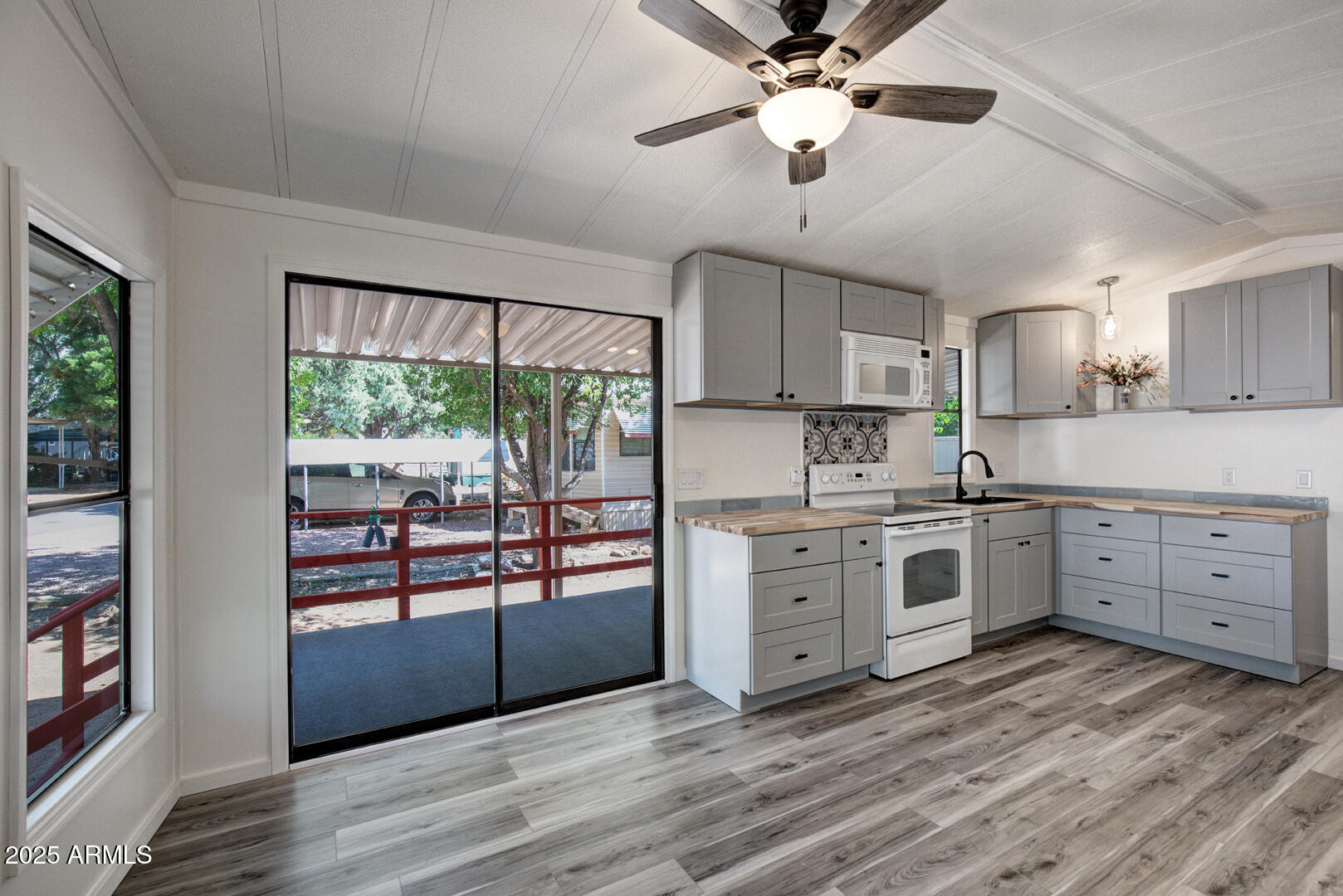 16 North Star Vale Road, Unit 11 Star Valley, AZ 85541 - Photo 10 of 24 a kitchen with white cabinets and wooden floor