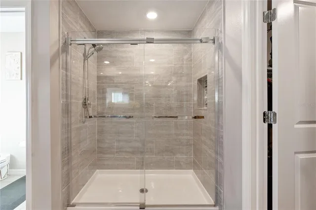 a view of walk in closet with clothes