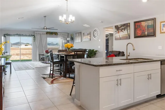 a kitchen with stainless steel appliances granite countertop a sink and a refrigerator