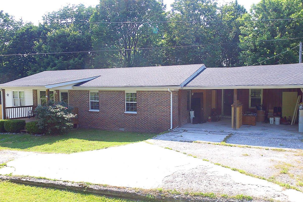 2779 Dale Ridge Road Dowelltown, TN 37059 - Photo 16 of 20 a front view of a house with a garden and yard