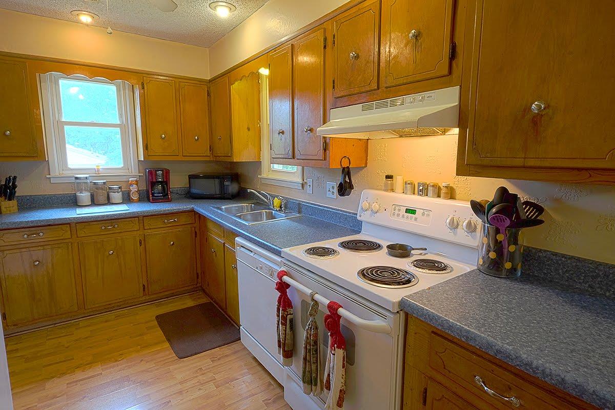 2779 Dale Ridge Road Dowelltown, TN 37059 - Photo 7 of 20 a kitchen that has a sink a stove and a wooden cabinets