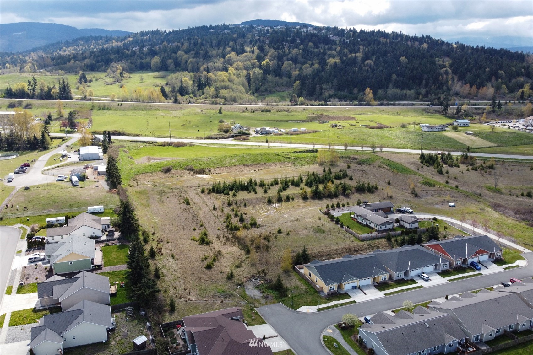 9999 Stratus Loop Sequim, WA 98382 - Photo 1 of 40 a view of swimming pool with a garden and mountain view in back