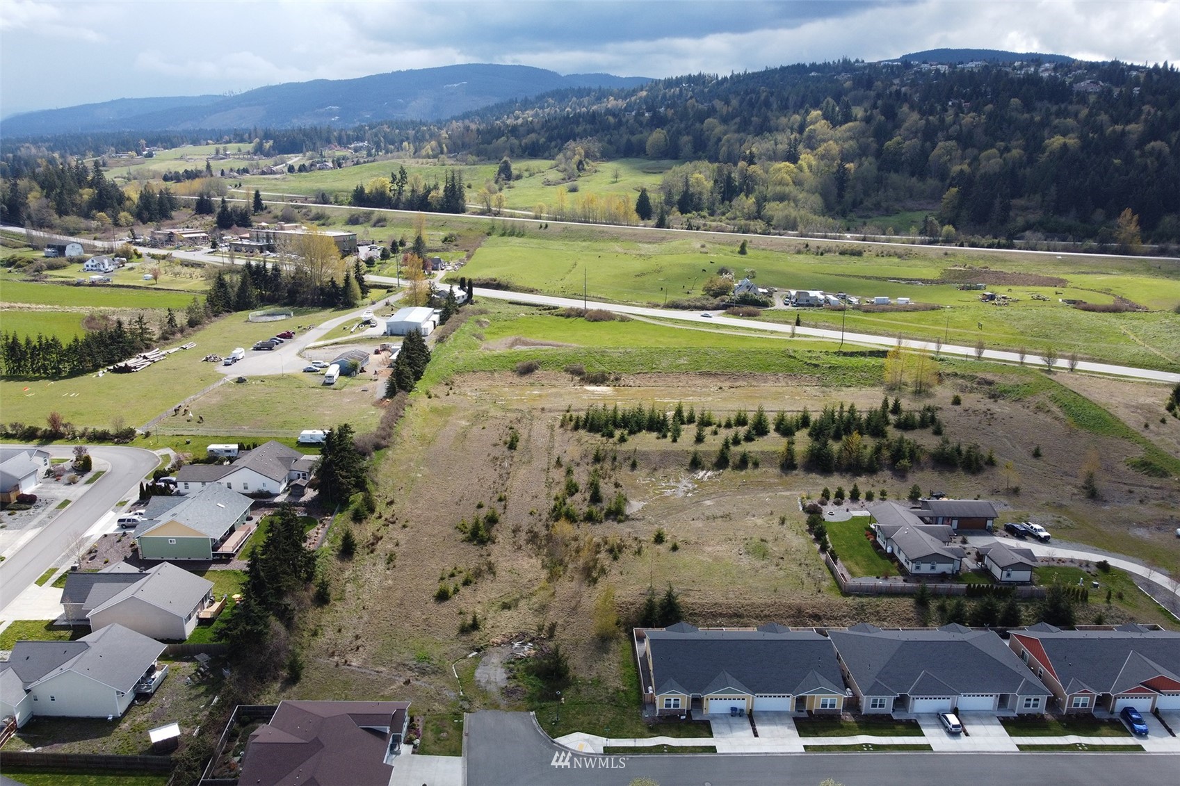 9999 Stratus Loop Sequim, WA 98382 - Photo 2 of 40 an aerial view of a house with a garden and lake view