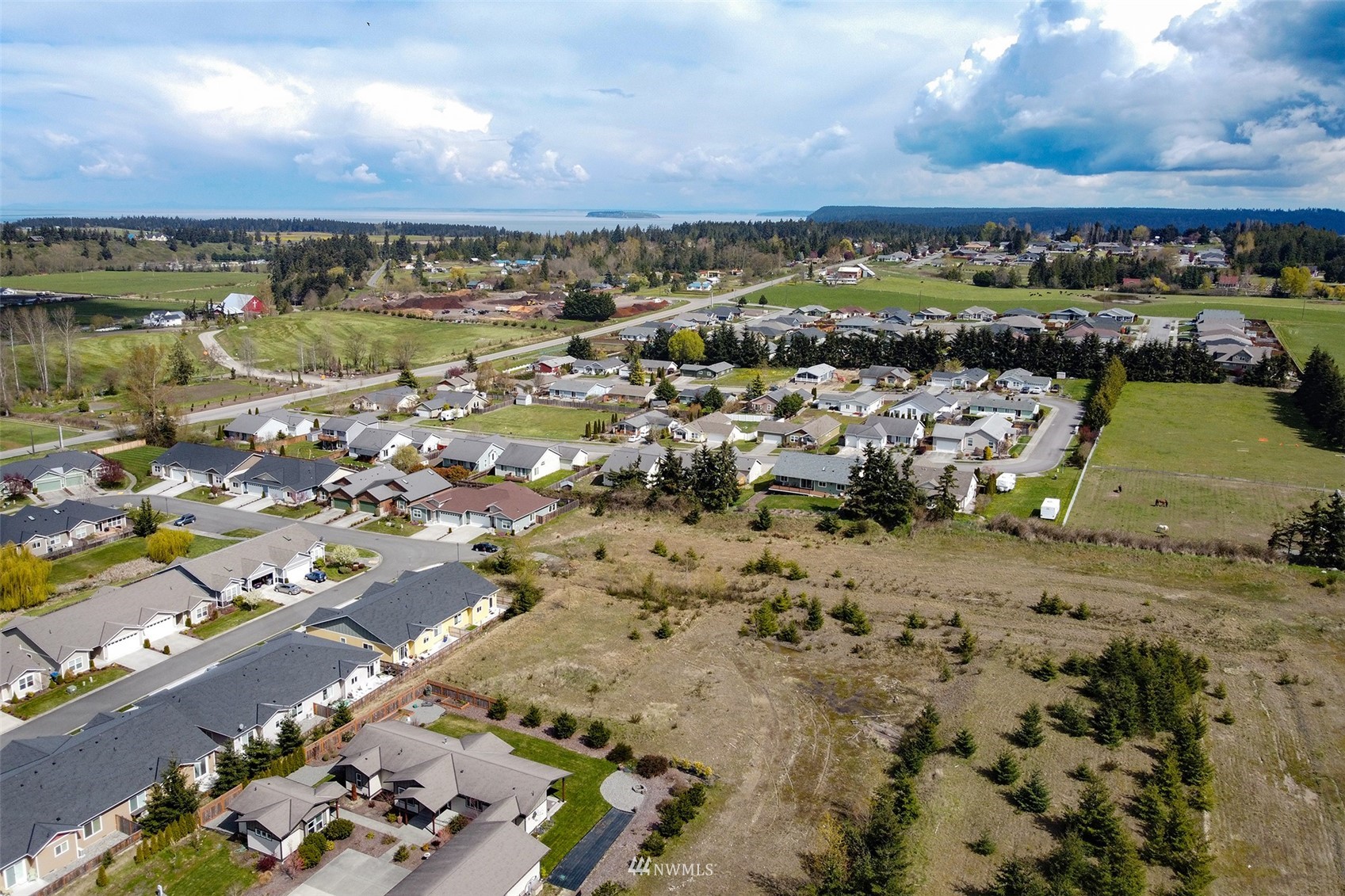 9999 Stratus Loop Sequim, WA 98382 - Photo 6 of 40 an aerial view of a building with a lake view