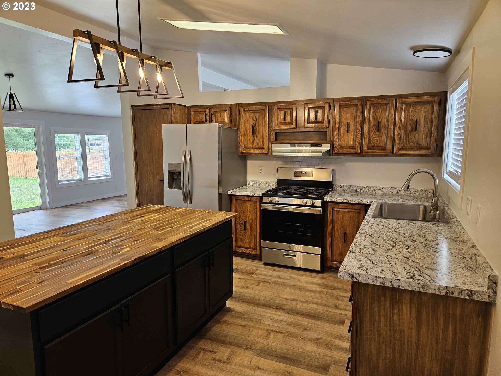 620 Southwest Mildred Avenue Enterprise, OR 97828 - Photo 11 of 26 a kitchen with stainless steel appliances granite countertop a sink stove and refrigerator