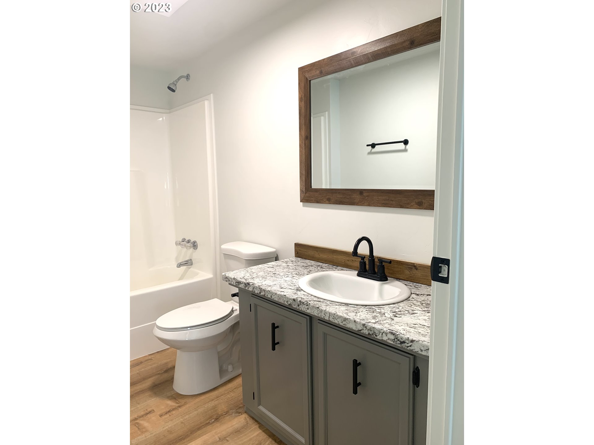 620 Southwest Mildred Avenue Enterprise, OR 97828 - Photo 19 of 26 a bathroom with a granite countertop sink and a mirror