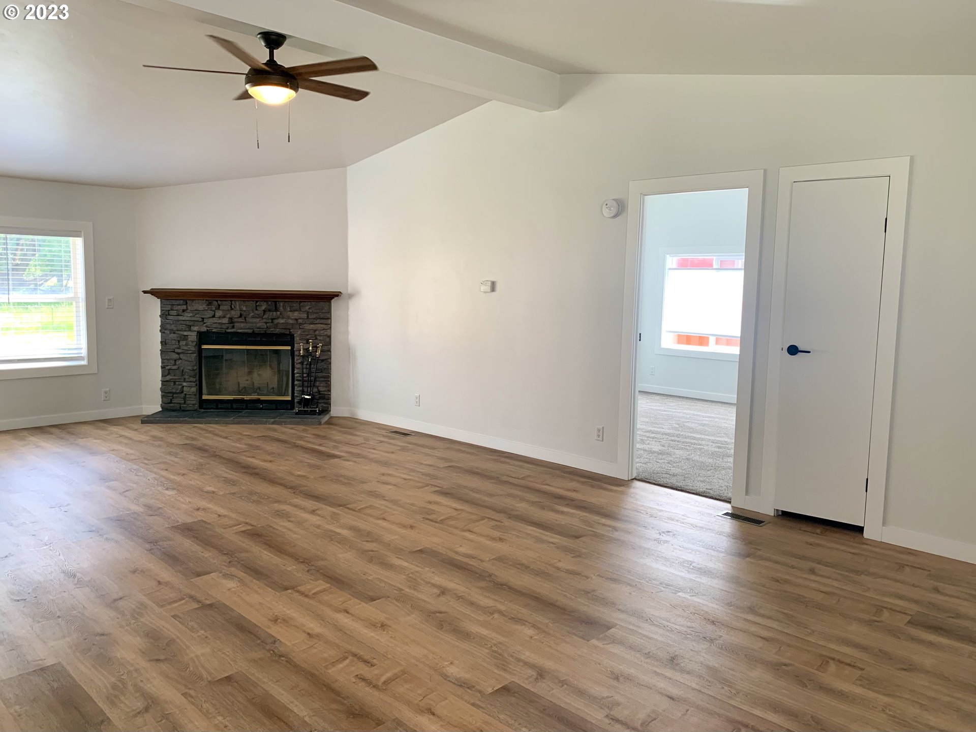 620 Southwest Mildred Avenue Enterprise, OR 97828 - Photo 4 of 26 an empty room with wooden floor fireplace and window