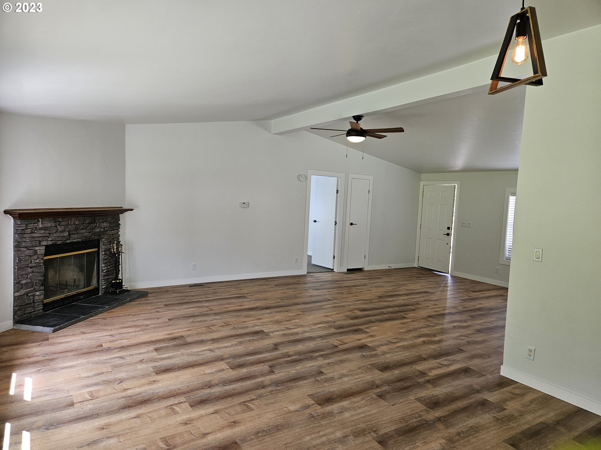 620 Southwest Mildred Avenue Enterprise, OR 97828 - Photo 6 of 26 a view of an empty room with wooden floor fireplace and a window
