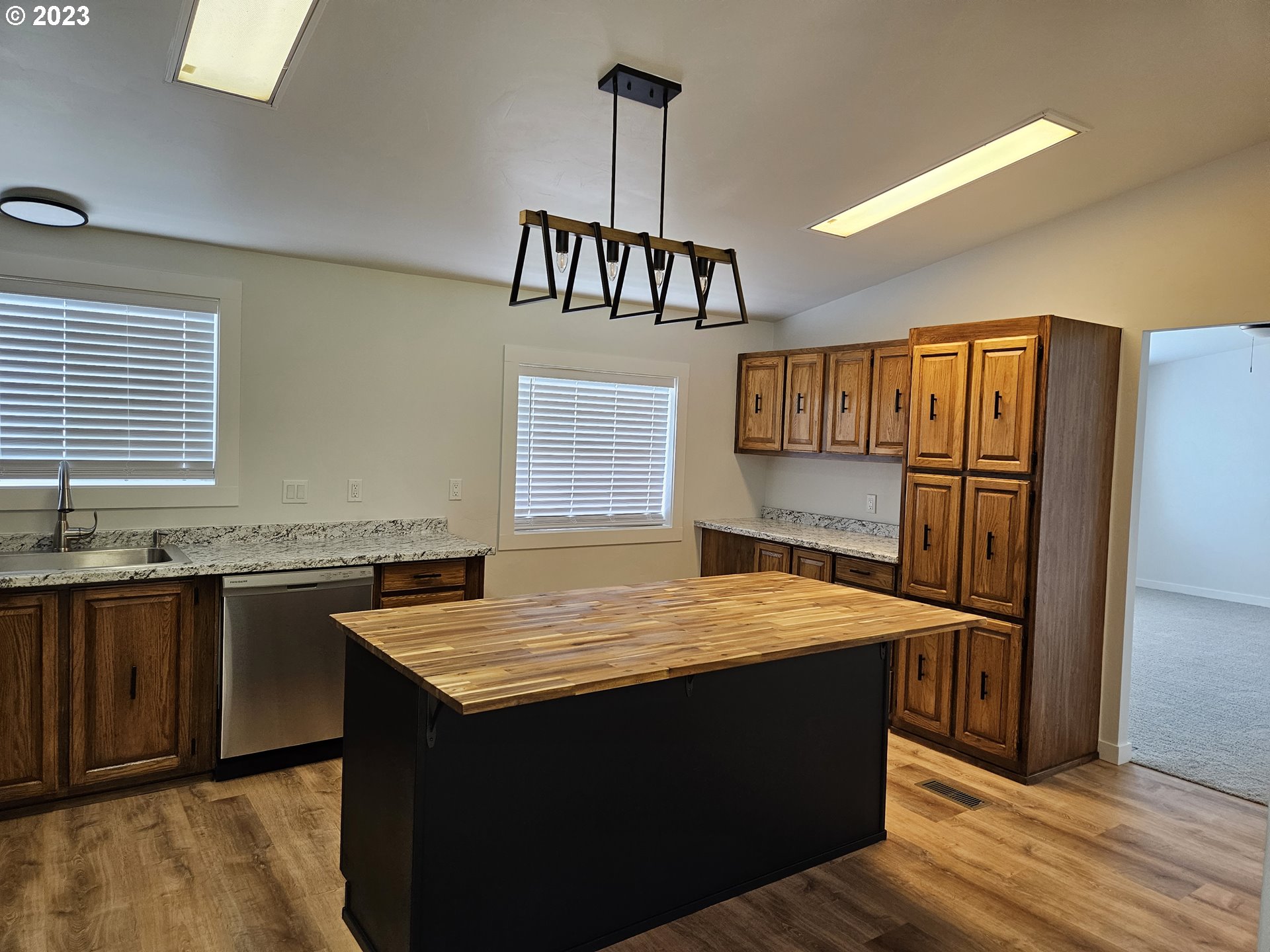 620 Southwest Mildred Avenue Enterprise, OR 97828 - Photo 10 of 26 a kitchen with granite countertop a refrigerator and a sink