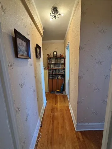 a view of a hallway with wooden floor