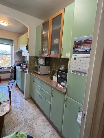 a kitchen with cabinets a stove and a refrigerator