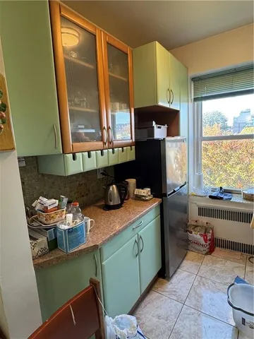 a kitchen with granite countertop a sink stove and cabinets