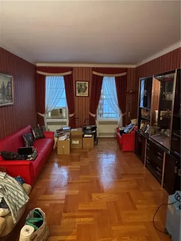 a living room with furniture a air conditioner vent and a window