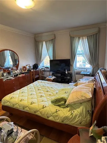 a bed sitting in a bedroom next to a window