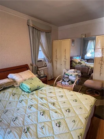a bedroom with two beds and a window