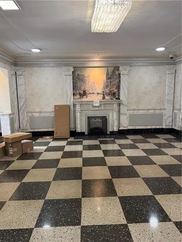 a view of a black and white checkered floor with a rug