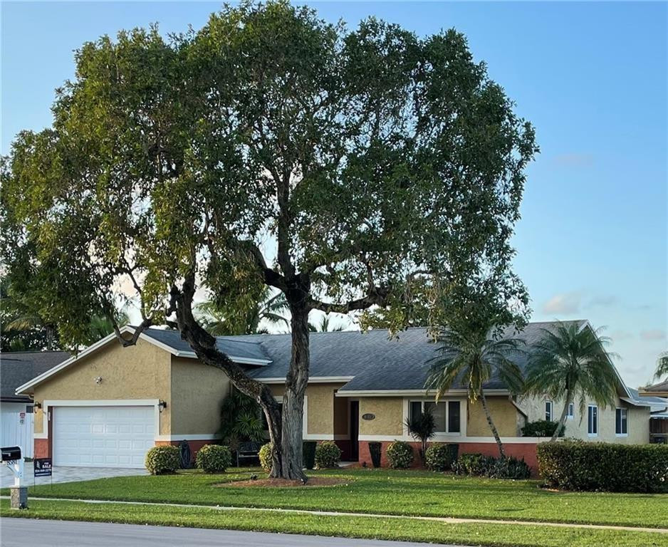 8581 Southwest 27th Place Davie, FL 33328 - Photo 2 of 10 a front view of a house with a garden
