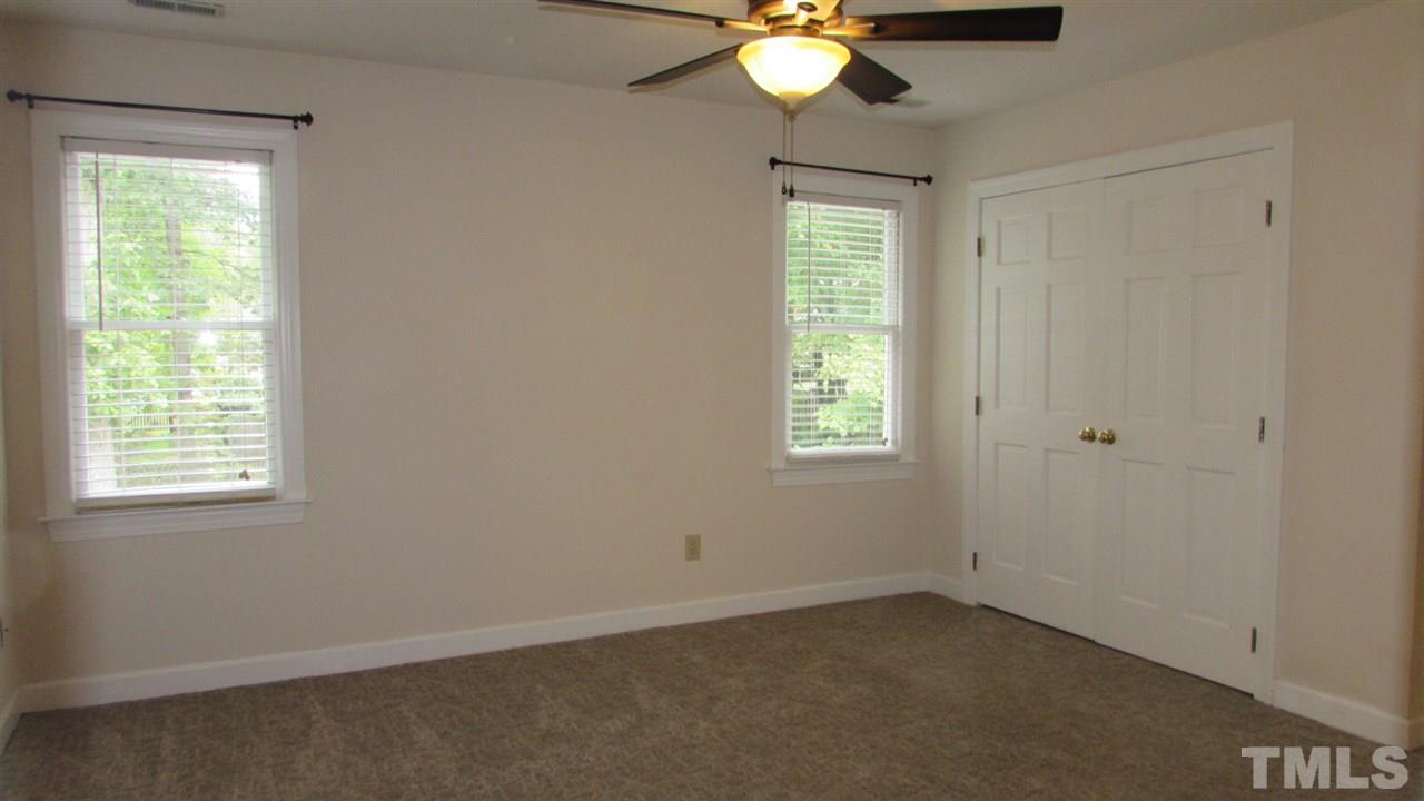 9517 Center Cross Court Raleigh, NC 27617 - Photo 11 of 24 Updated Master Bedroom with new carpet and ceiling fan.