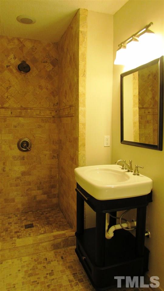 9517 Center Cross Court Raleigh, NC 27617 - Photo 12 of 24 Updated Master Bathroom with dual sinks and custom tiled shower and floors.