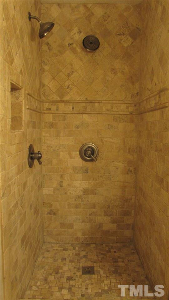 9517 Center Cross Court Raleigh, NC 27617 - Photo 14 of 24 TWO heads in the spa-like master bathroom custom tiled shower.