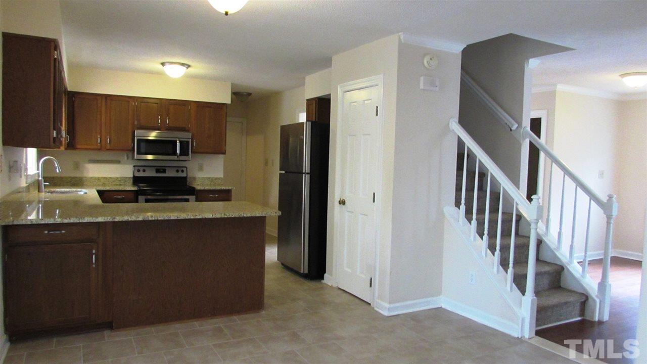 9517 Center Cross Court Raleigh, NC 27617 - Photo 4 of 24 New tile floor installed in the kitchen and laundry room.
