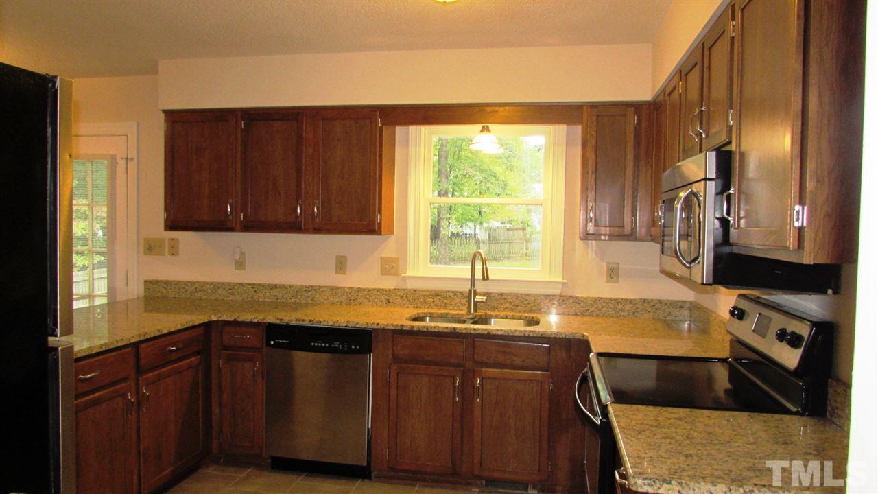 9517 Center Cross Court Raleigh, NC 27617 - Photo 6 of 24 Updated Kitchen with granite counter tops, stainless steel appliances and new tile floors. Refrigerator, washer and dryer convey!