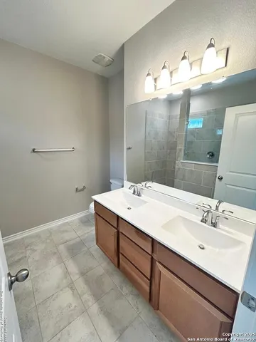 a bathroom with a sink vanity and mirror
