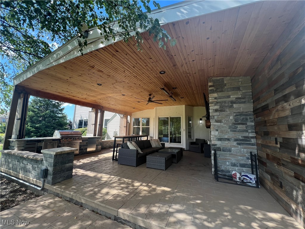 7305 Alexander Road Painesville, OH 44077 - Photo 49 of 50 View of patio featuring an outdoor living space, an outdoor kitchen, fireplace tv and a ceiling fan