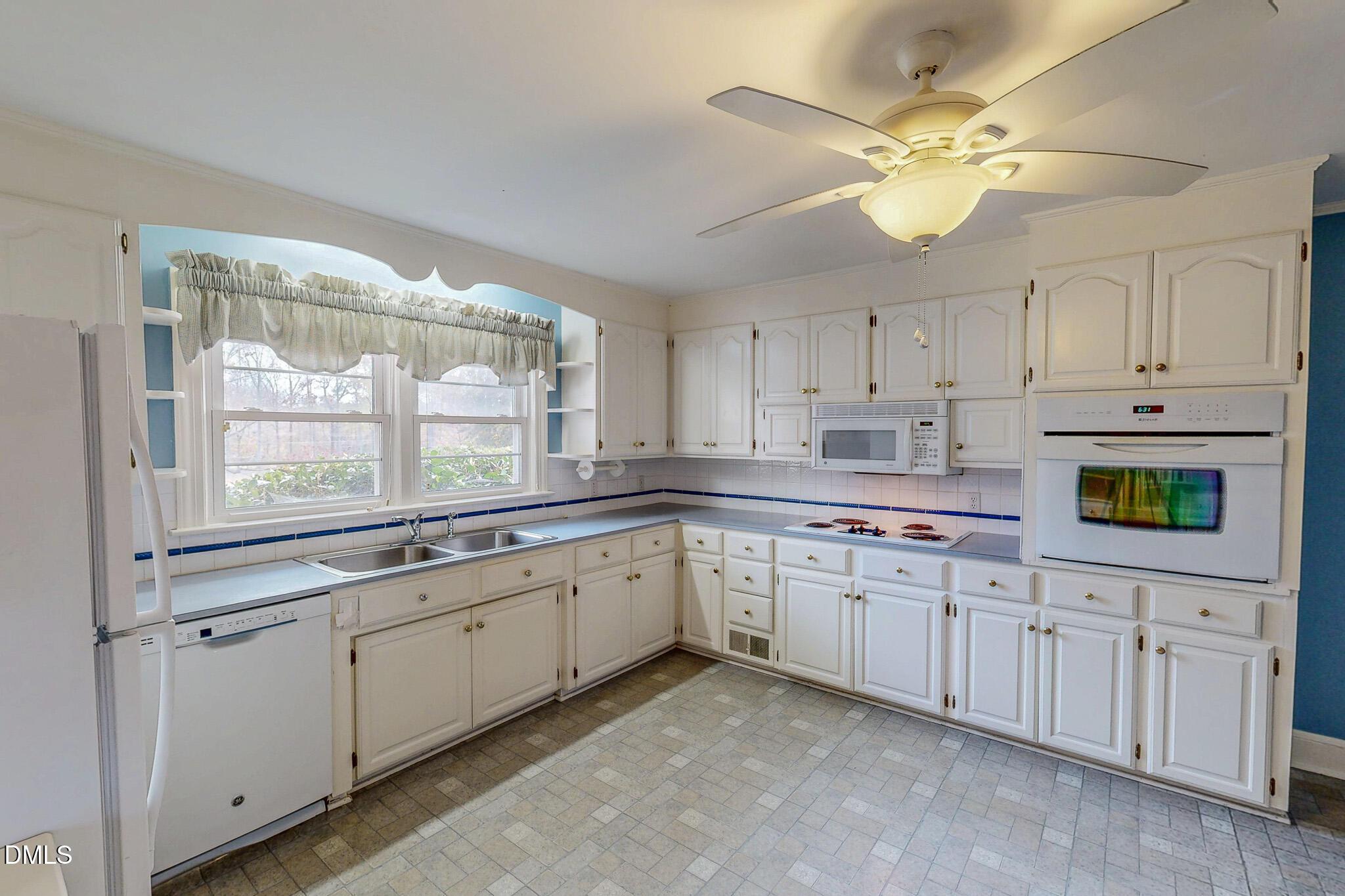 8758 Hurdle Mills Road Hurdle Mills, NC 27541 - Photo 17 of 53 a kitchen with a sink dishwasher and white cabinets with wooden floor