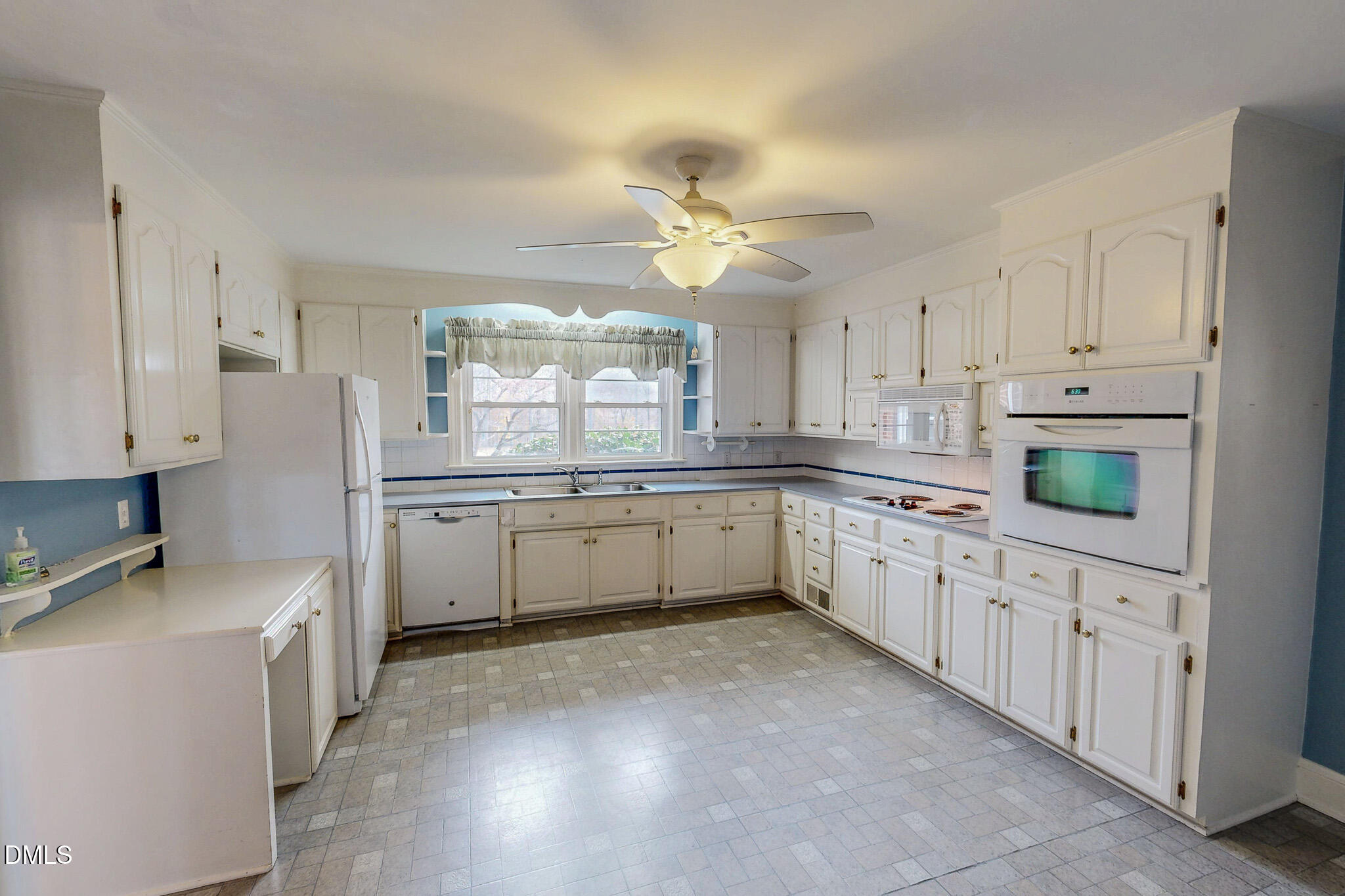 8758 Hurdle Mills Road Hurdle Mills, NC 27541 - Photo 18 of 53 a kitchen with granite countertop white cabinets white stainless steel appliances with a sink and dishwasher