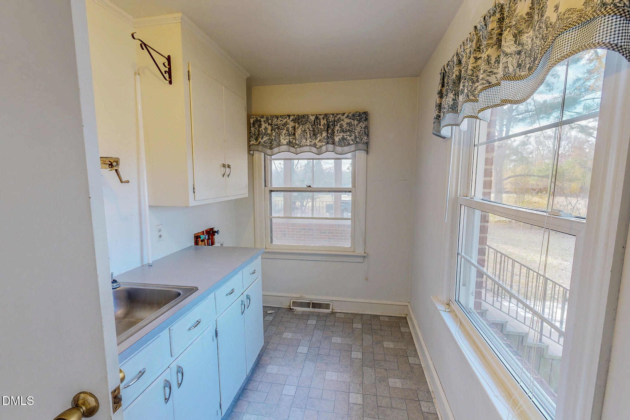 8758 Hurdle Mills Road Hurdle Mills, NC 27541 - Photo 21 of 53 a kitchen with a sink window and cabinets