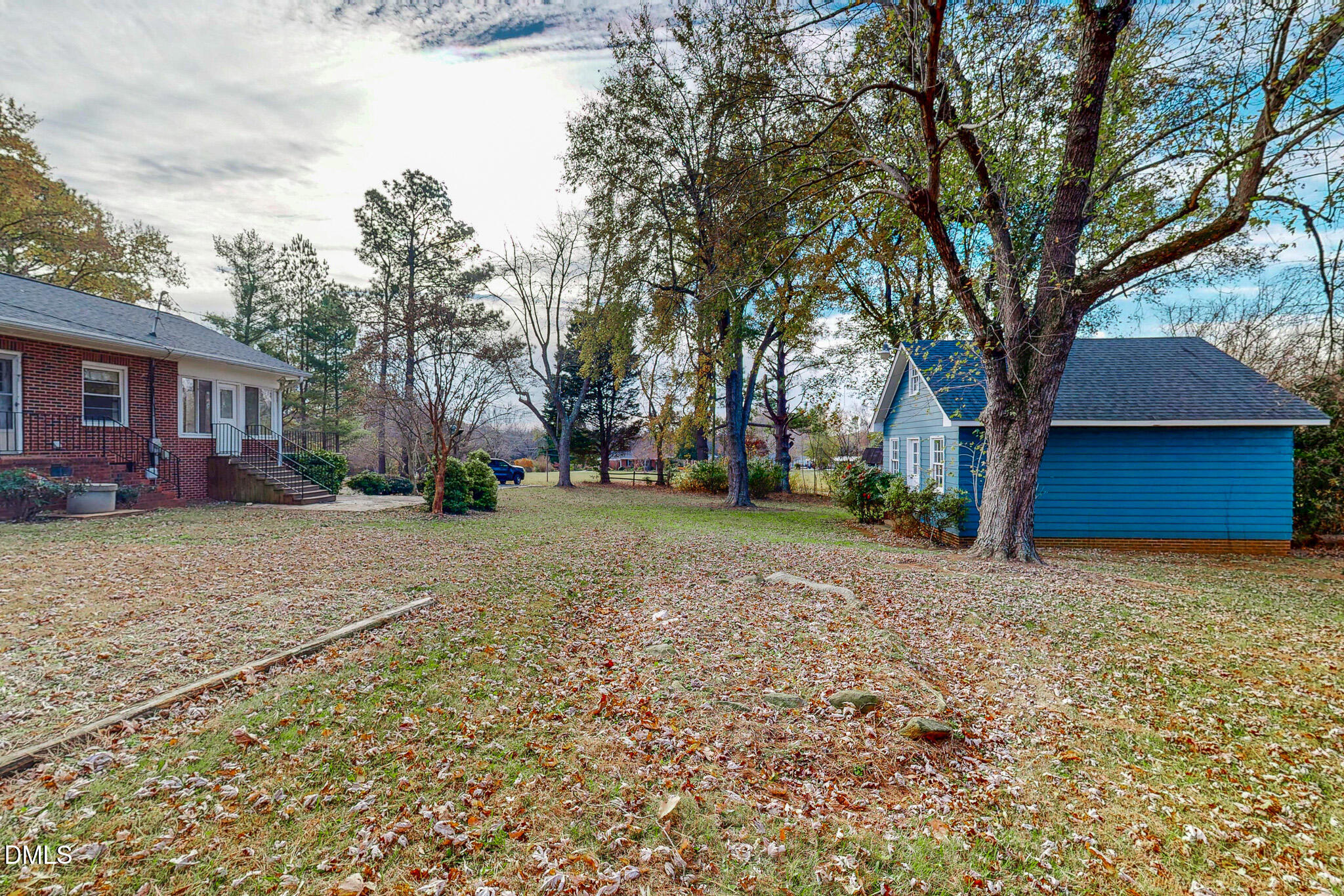 8758 Hurdle Mills Road Hurdle Mills, NC 27541 - Photo 33 of 53 a house with trees in front of it