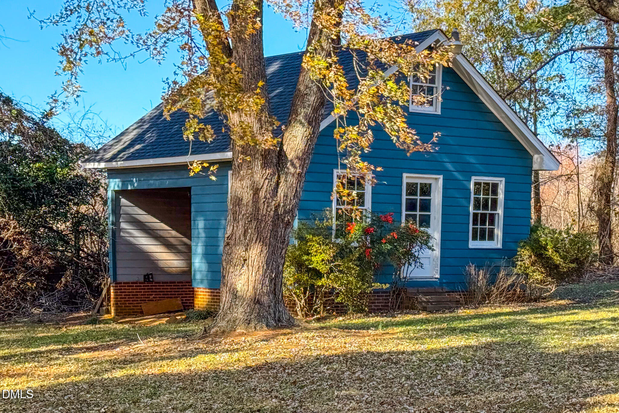 8758 Hurdle Mills Road Hurdle Mills, NC 27541 - Photo 35 of 53 a view of a house with a small yard plants and large tree
