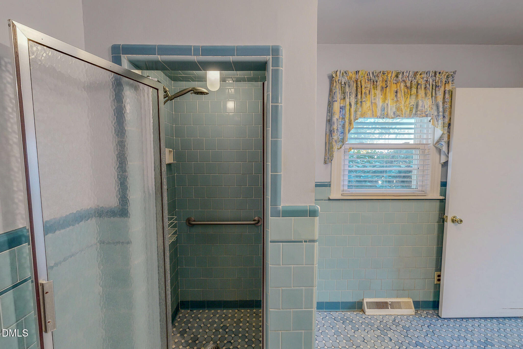 8758 Hurdle Mills Road Hurdle Mills, NC 27541 - Photo 39 of 53 a bathroom with a shower and a window