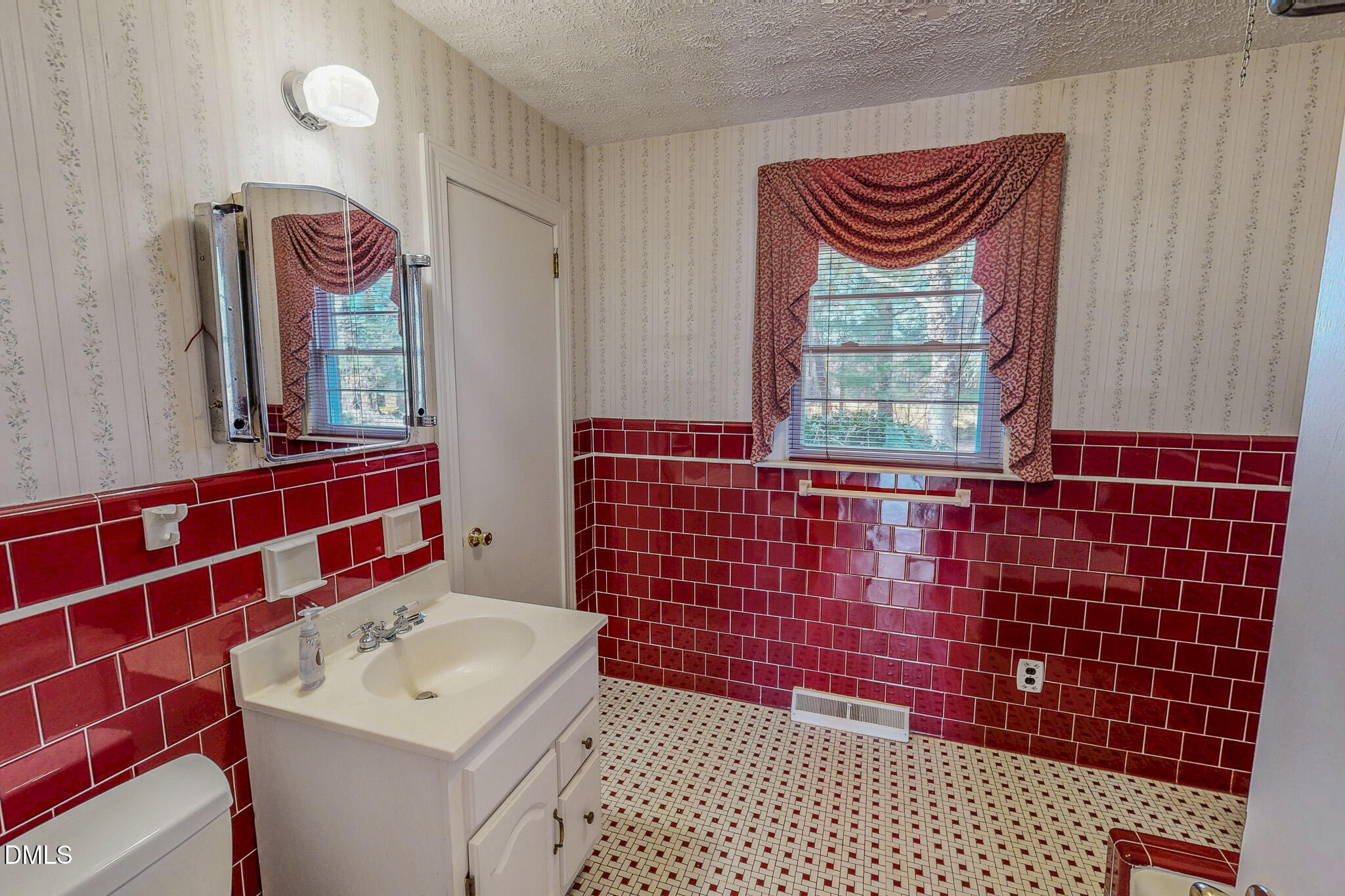 8758 Hurdle Mills Road Hurdle Mills, NC 27541 - Photo 46 of 53 a bathroom with a sink a mirror and shower