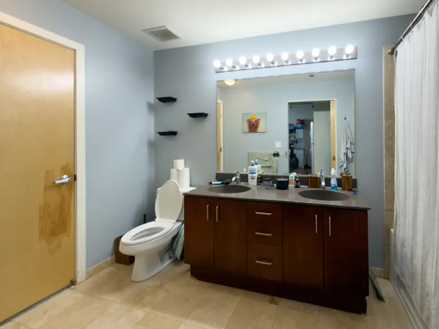 a bathroom with a toilet sink and mirror