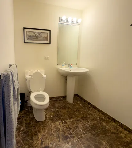 a utility room with dryer washer and wooden floor