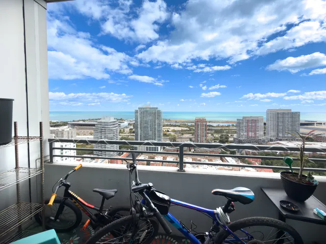 a view of a balcony with wooden floor and city view