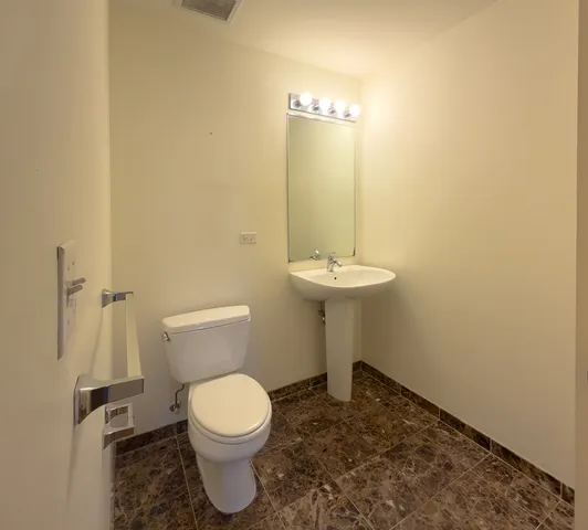 a bathroom with a toilet and a sink