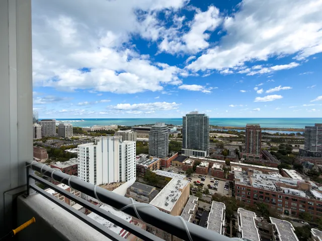 a view of a balcony with wooden floor and city view
