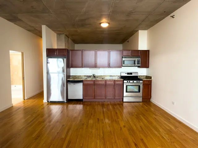 a kitchen with stainless steel appliances a refrigerator and a microwave
