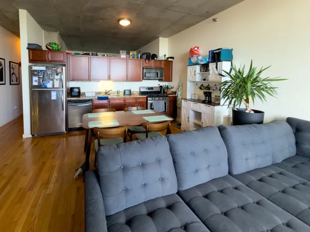 a living room with furniture and a kitchen view